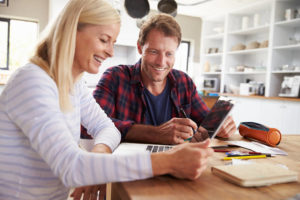 middle aged couple looking at company websites in Stafford