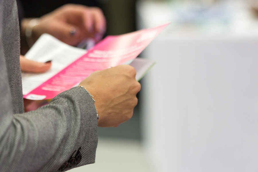 woman in fredericksburg holding business flyer